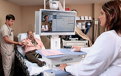 Nurse saying hi to patient on computer