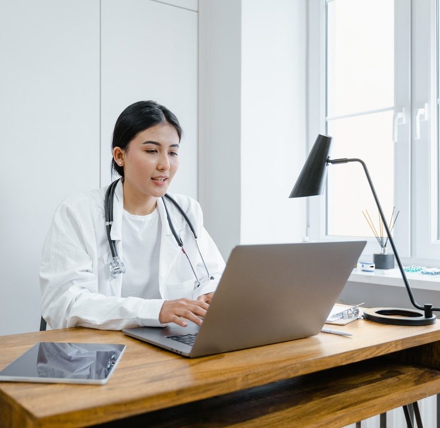Female doctor conferencing with laptop