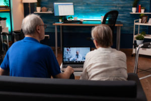 Elderly couple contacting doctor using telehealth services