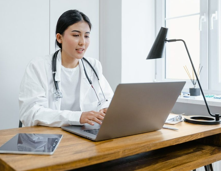 doctor talking to client online on her laptop