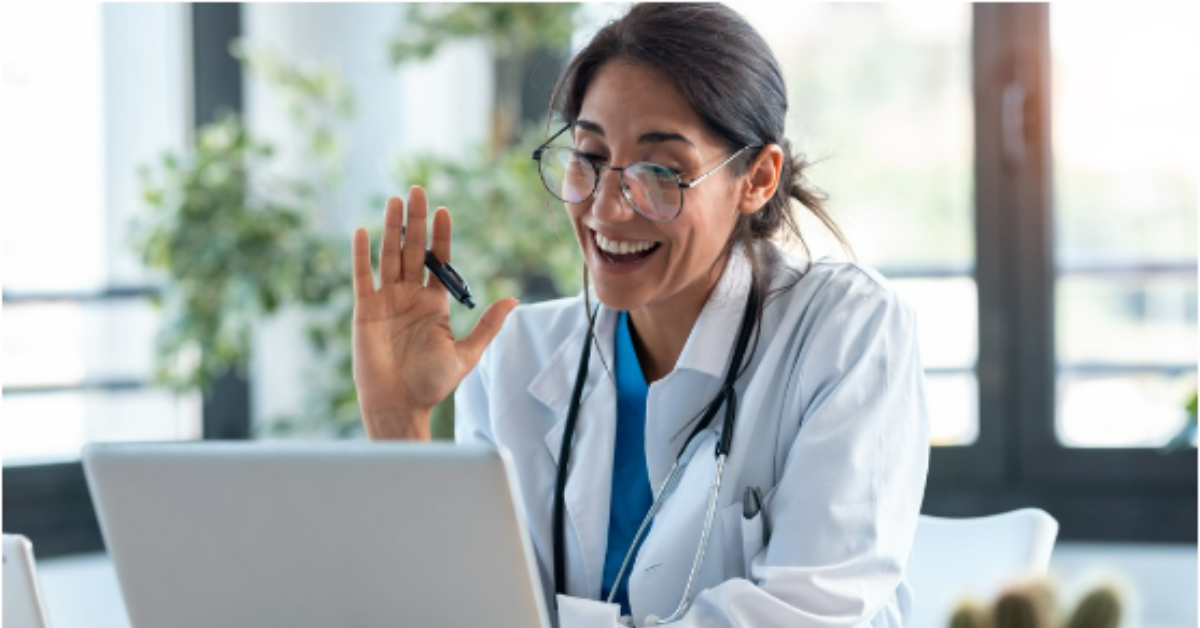 Nurse saying hi to patient on computer