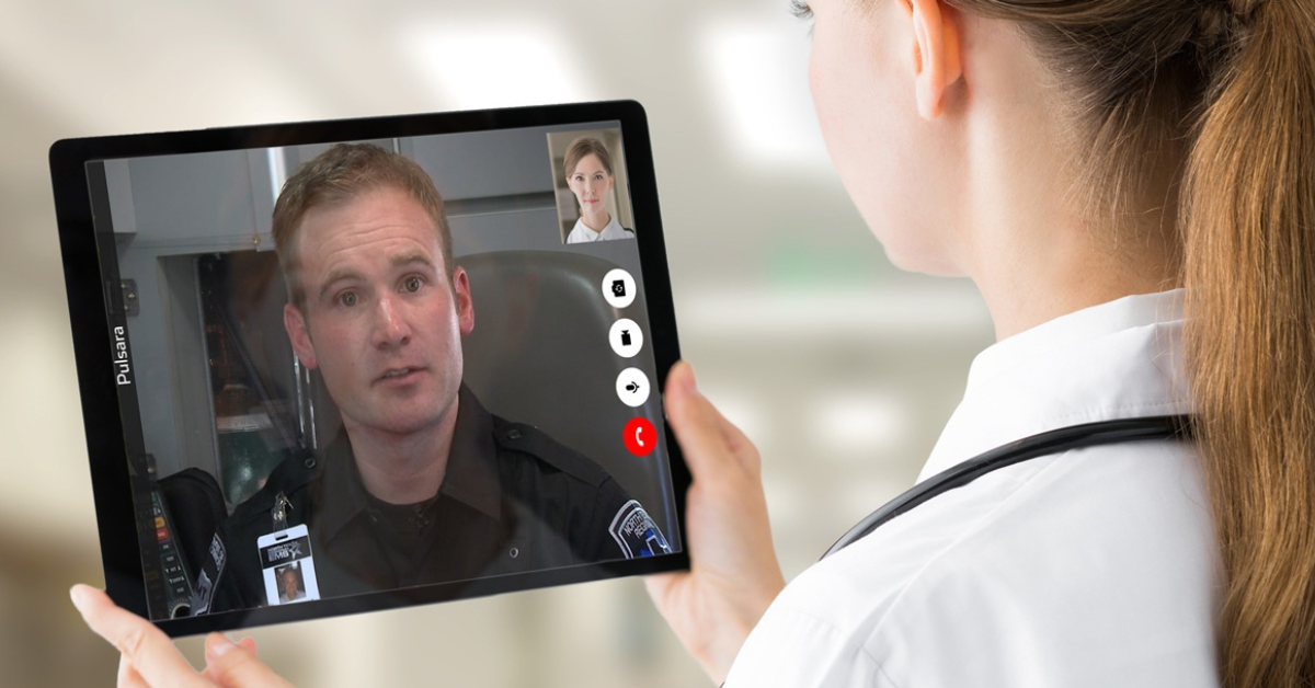 female doctor talking to EMT through tablet