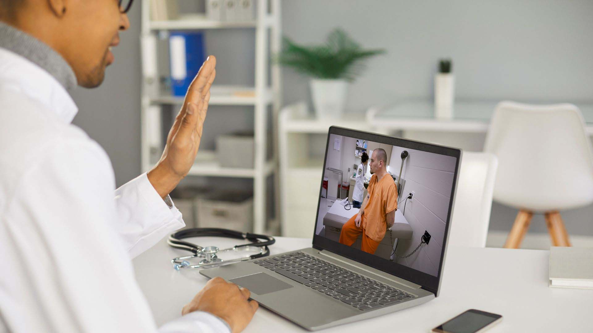 Doctor seeing inmate through telehealth