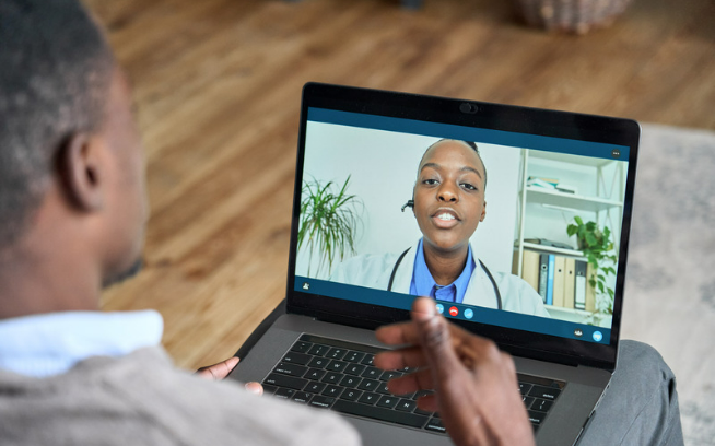 a black male having doctor appointment through telehealth solution