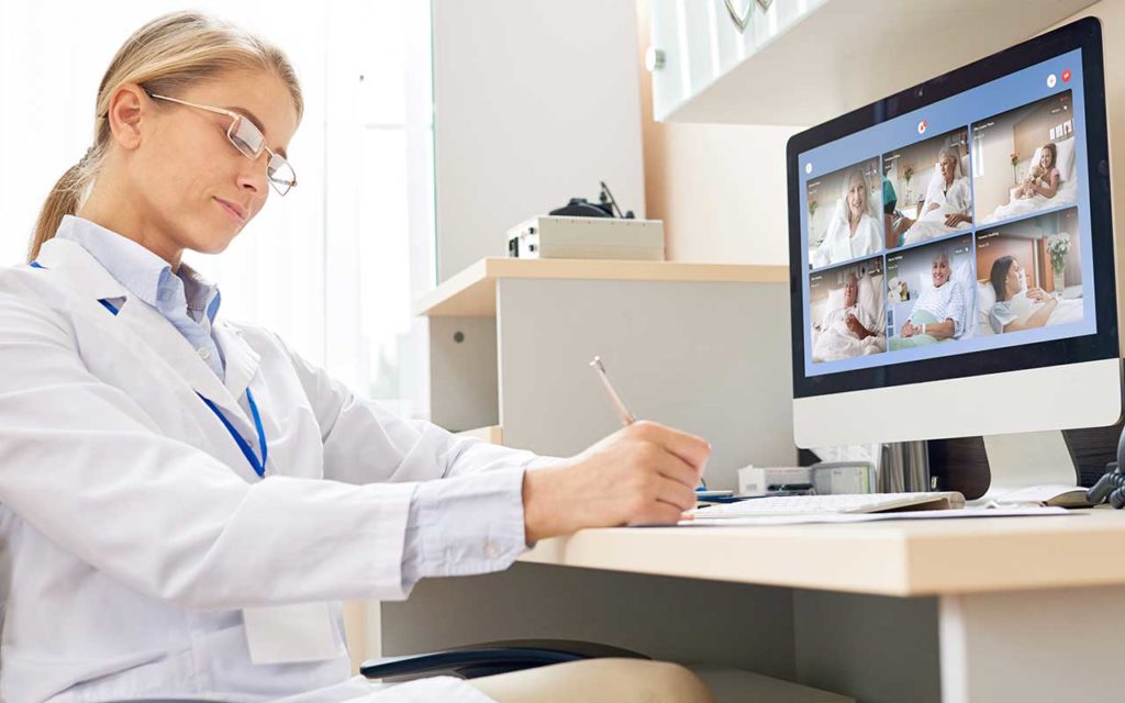 female doctor monitoring patient on computer