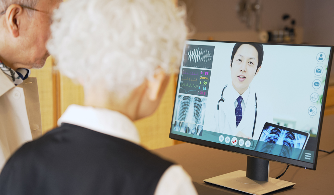 Elderly couple accessing rural healthcare services on a desktop