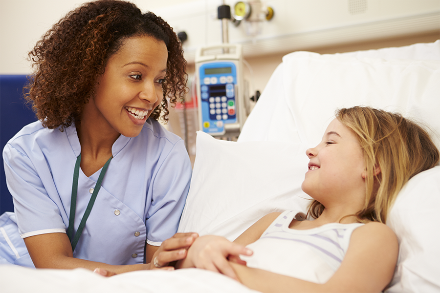 female doctor talking to a girl in hospital bed